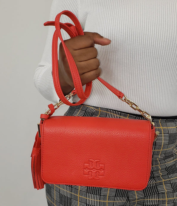 Brilliant Red mini bag with  Gold-toned hardware featuring gold chain links on strap 100% pebbled leather Stitched Tory Burch logo detail  Removable tassels  Flap top with magnetic snap closure  Interior: Logo lining; one multifunction slip pocket. Adjustable/ detachable leather strap for shoulder/crossbody wear 8