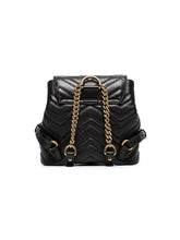 Load image into Gallery viewer, The Gucci Black Marmont Quilted Leather Backpack features adjustable shoulder straps with post-stud fastening. Logo plaque at face. Fold over flap with magnetic tab fastening. Drawstring fastening at throat. Patch pocket and leather logo flag at interior. Leather lining in beige. Antiqued gold-tone hardware. Tonal stitching.