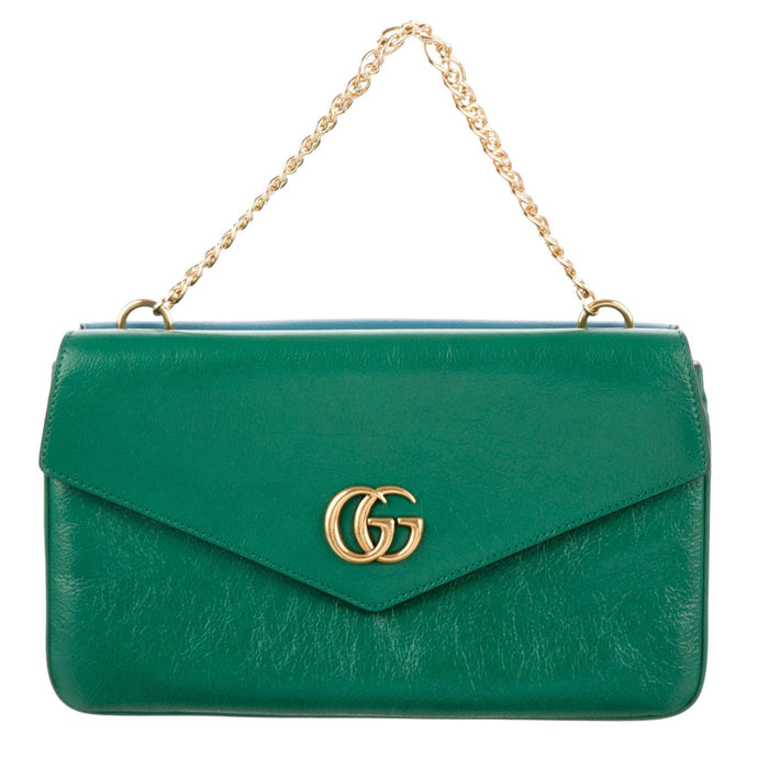This is a two toned, double sided Gucci bag. The style is called Thiara and it looks like two envelopes back to back. One side is a mellow Robin blue. The other side is a jade green. The blue side has a jewel encrusted Raja tiger head on the magnetic clasp. The green side has the iconic double GG on the button clasp. There is a fixed Gucci gold short chain on the top and a strap is also included to make this a should bag or crossbody.