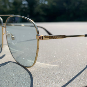 Gucci Metal Framed Navigator Sunglasses in Gold