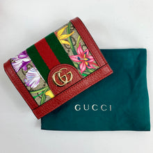 Load image into Gallery viewer, Red Ophidia GG Flora Card Case Wallet Flora pattern body Gold-tone hardware  GG Supreme canvas Pebbled leather trim and interior  Signature Gucci web Double GG logo  Flap top with snap closure  1 zipped pouch, 1 bill slot, 5 card slots 3.5&quot; x 4.5&quot; x 1&quot; Comes in green dust bag and holographic palm tree box Product number 523155 Made in Italy 