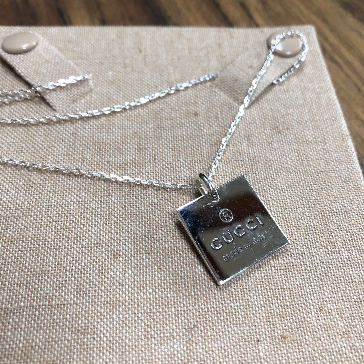 Gucci sterling silver necklace with lobster clasp. Square pendant with GUCCI logo and "made in Italy" stamped for design. Simple, classy, everyday piece.