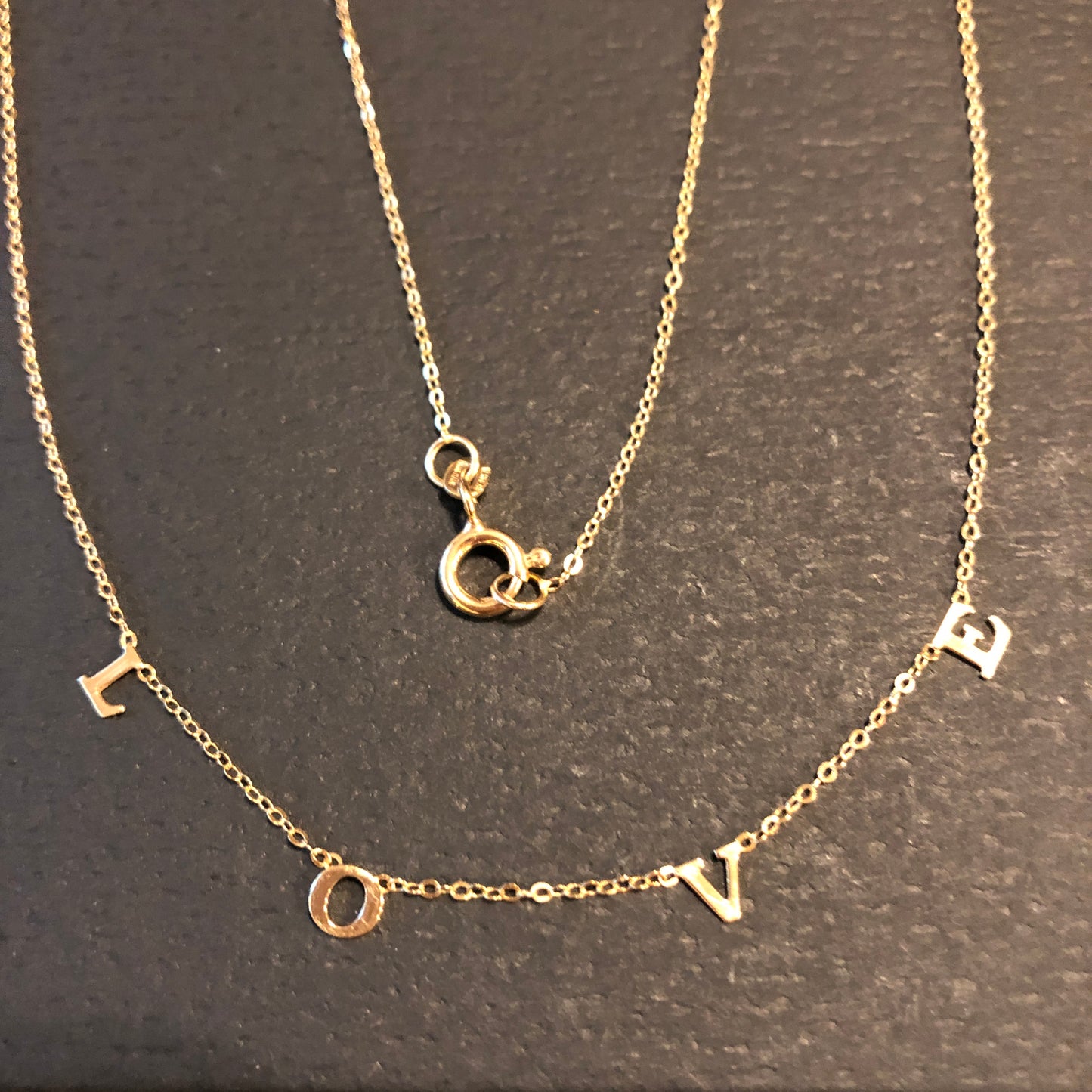 We love LOVE. This 14k gold necklace has the word "LOVE" spelled out on a delicate chain. A perfect wayt o express yourself or give a gift to the one you love.