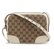 Load image into Gallery viewer, The Gucci GG Supreme Bree Camera Crossbody Bag in Ivory is made in Italy from quality supreme canvas in the signature interlocking GG pattern, and trimmed with smooth calfskin leather. This crossbody bag features the guccissima pattern, reenforced edges, an adjustable strap, GG charm, slip pocket, and 8 card slots. 