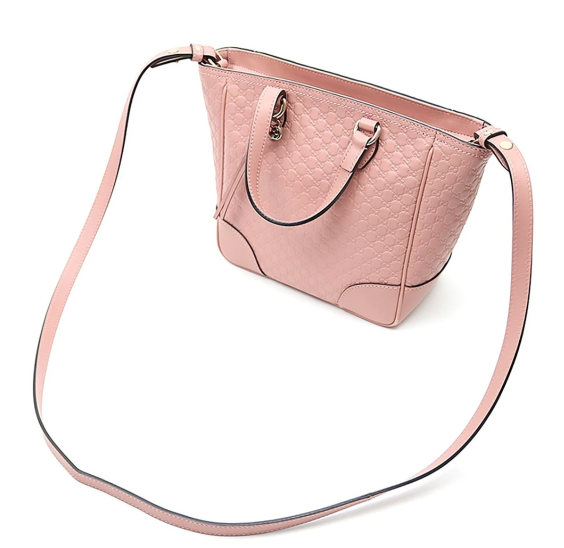 Pink crossbody tote bag Gold-tone hardware featuring Gucci charm 100% leather in GG Microguccissima pattern Linen interior lining Top zip closure Detachable and adjustable shoulder strap 2 slip pouches, 1 zipped pocket Leather tassel detail 8.5" x 11.5" x 4.5" Strap Drop 19-21 Handle drop 3.5" Product number 449241 Made in Italy