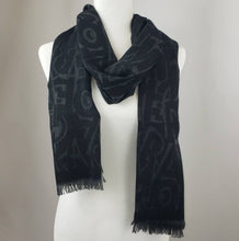 Load image into Gallery viewer, Black is a staple color in everyones wardrobe, and scarves are no exception! This luxurious scarf is a beautiful blend of black and charcoal gray with a Ferragamo lettering pattern woven throughout. This piece is perfect to add depth and texture to your outfit in a stylish way.