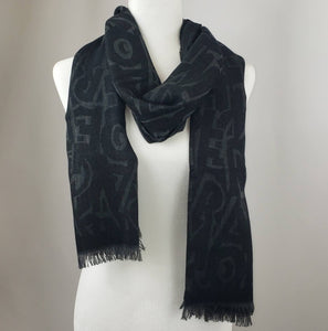 Black is a staple color in everyones wardrobe, and scarves are no exception! This luxurious scarf is a beautiful blend of black and charcoal gray with a Ferragamo lettering pattern woven throughout. This piece is perfect to add depth and texture to your outfit in a stylish way.
