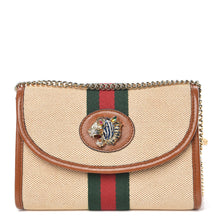 Load image into Gallery viewer, The Gucci Rajah Mini Canvas Shoulder Bag is a classic bag in the luxury we expect from a renowned designer. Durable beige canvas is trimmed in tan leather and has the signature Gucci web running down the center. A lions head adorns the center of the bag, embellished with blue, red, and white crystal details. A polished gold-tone chain strap allows this piece to be worn as a clutch or shoulder bag while the interior card cases allow you to forgo a bulky wallet. 