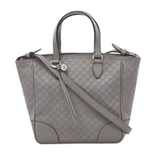 Load image into Gallery viewer, This Gucci GG Logo Microguccissima gray handbag is so cute and perfect for everyday. In a versitile design that effortlessly transitions from handbag to shoulder bag, this accessory can follow you in any situation! The interior is lined in soft, durable linen and includes 2 slip pockets and 1 zipped pocket to keep you organized all day long. Complete with a cute Gucci charm and leather tassel, this bag has all the class you need to style any outfit!