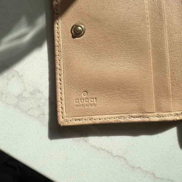 PREOWNED Gucci Beige Wallet with Gold Heart Logo