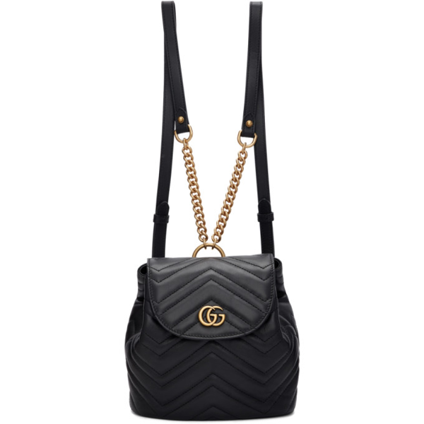 The Gucci Black Marmont Quilted Leather Backpack features adjustable shoulder straps with post-stud fastening. Logo plaque at face. Fold over flap with magnetic tab fastening. Drawstring fastening at throat. Patch pocket and leather logo flag at interior. Leather lining in beige. Antiqued gold-tone hardware. Tonal stitching.