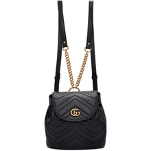 Load image into Gallery viewer, The Gucci Black Marmont Quilted Leather Backpack features adjustable shoulder straps with post-stud fastening. Logo plaque at face. Fold over flap with magnetic tab fastening. Drawstring fastening at throat. Patch pocket and leather logo flag at interior. Leather lining in beige. Antiqued gold-tone hardware. Tonal stitching.