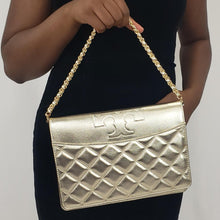 Load image into Gallery viewer, The Tory Burch Savannah clutch is gold and shimmery to match a sparkly personality! In an elegant and sophisticated shine, this golden bag is made in an embossed leather with a diamond pattern and adorned with a signature Tory Burch &quot;T&quot;.  The gold chain handbag strap is woven with shimmering gold leather, and there is a detachable shoulder strap for versatility. The perfect accessory to a little black dress! 