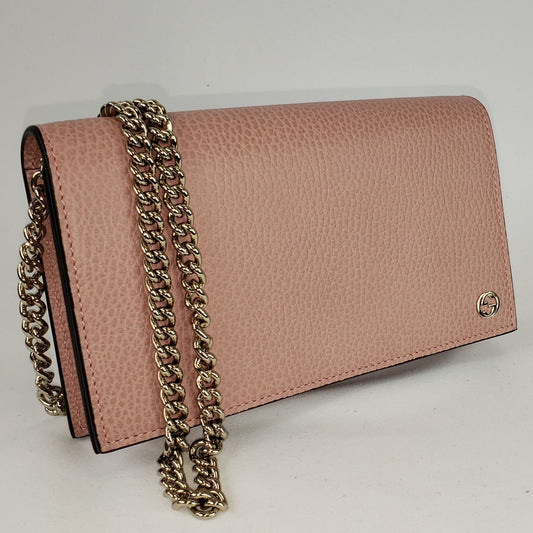 This chic wallet on chain is crafted of textured calfskin leather. The shoulder bag features a shoulder chain and a small Gucci GG emblem. It opens to a matte leather interior with a spacious zippered currency compartment, and card slot panels. This is an ideal chain wallet for keeping contents close at hand, by Gucci! The chain is removable so you can carry this bag as a wallet or wear is as a cross body.