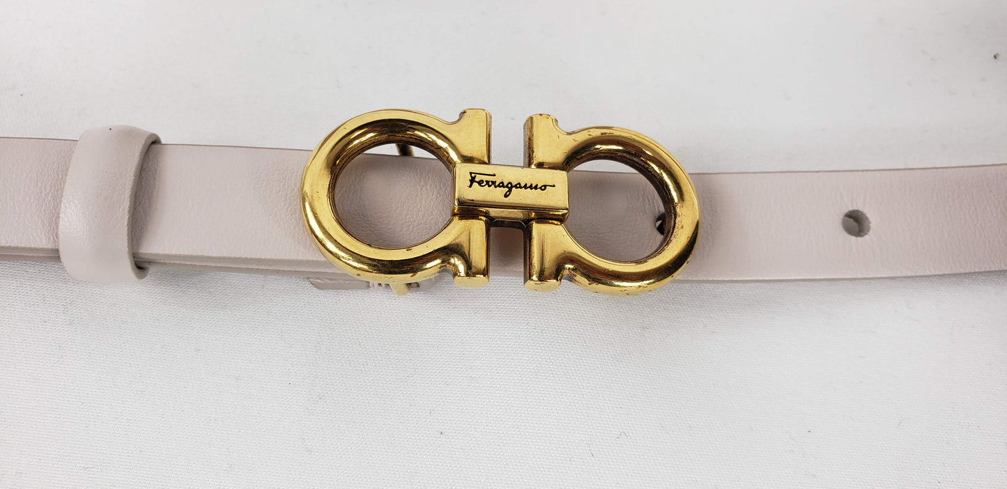 This simple and trendy belt is a great accessory to pull an outfit together! As we know, the belt can make or break an outfit and this soft creamy leather will never let you down. It is a thinner belt that will fit through most belt loops, and can also be worn around your waist to accentuate your figure. The gold buckle is shaped in the classic Ferragamo logo that creates a trendy shine.