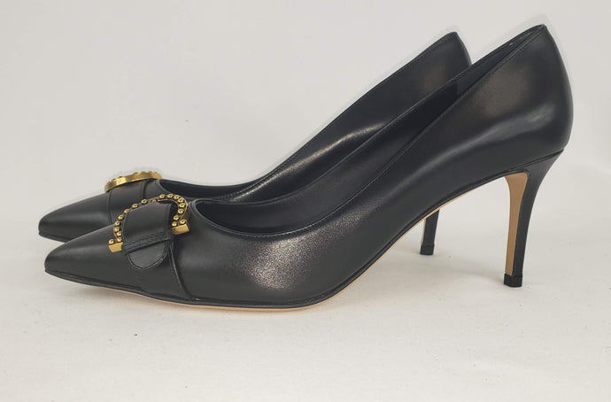 Black pumps are a must have in any closet, and these Ferragamo Black Airola pumps are one of our favorites! In a chic black leather with an elegant silhouette, this pointed toe feel is perfect for business professional looks or nighttime fits. Featuring a leather buckle and gold signature Gancini accent, this is a sophisticated showstopper. Paired with jeans or a little black dress, this shoe is sure to complete your look!