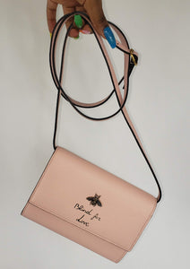 Made in Perfect Pink with an adorable gold bee accent and "blind for love" lettering, this small purse is a great addition to your look! Supple leather comes together with a snap closure for a simplistic, elegant design. The interior is spacious enough to hold your beloved devices, and also has 4 card slots to keep you organized. Use as a crossbody bag or remove the strap and use it as a clutch.