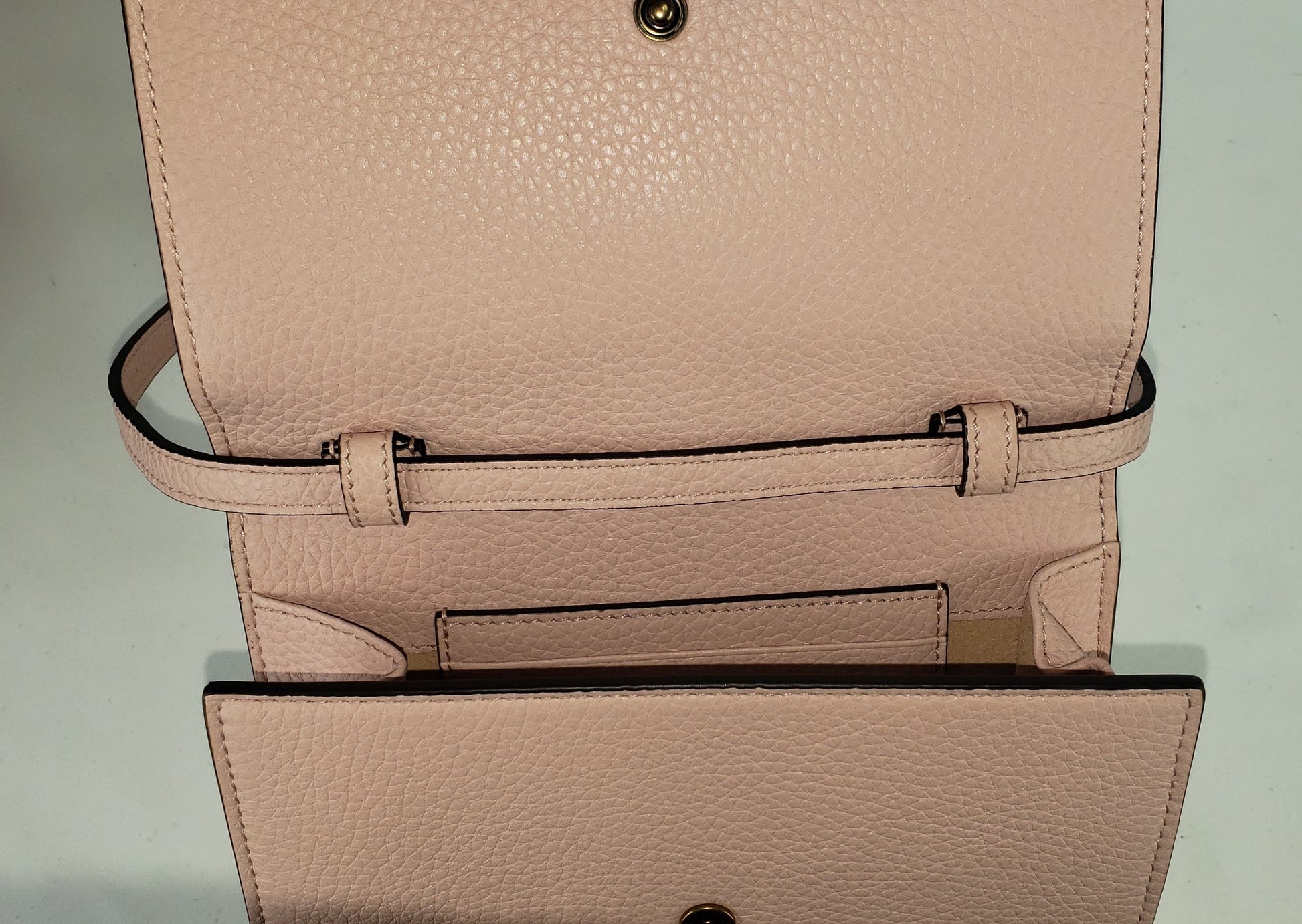 Made in Perfect Pink with an adorable gold bee accent and "blind for love" lettering, this small purse is a great addition to your look! Supple leather comes together with a snap closure for a simplistic, elegant design. The interior is spacious enough to hold your beloved devices, and also has 4 card slots to keep you organized. Use as a crossbody bag or remove the strap and use it as a clutch.