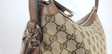 Load image into Gallery viewer, Beige bag in GG logo pattern with brown trim, strap, and accents Gold-toned hardware  GG canvas with leather straps and tabs  2 slip pouches and 1 zippered pocket 15” x 13” x 4.5” Comes with Gucci dust bag and cards  Product number 449244 Made in Italy