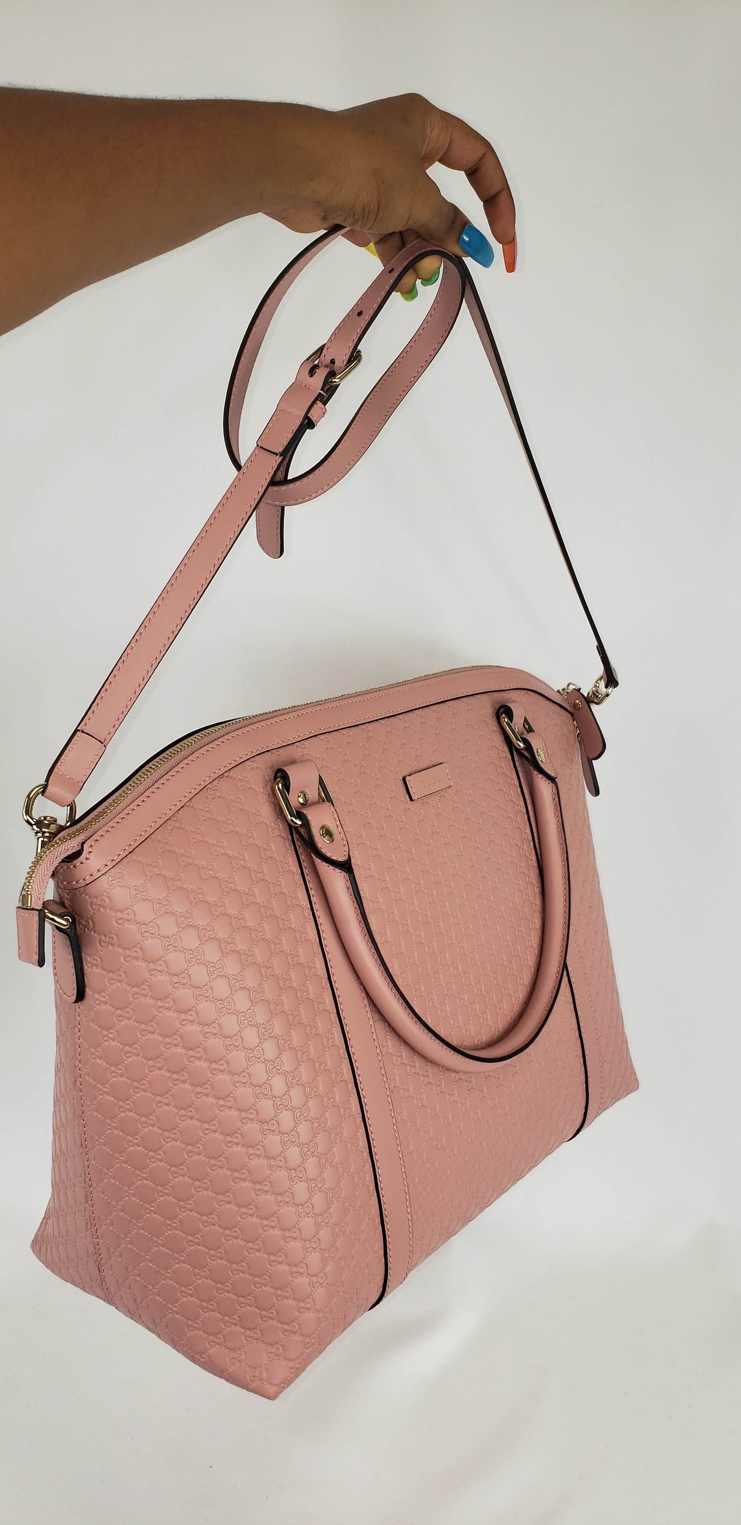 Soft pink convertible handbag in GG pattern Light fine silver-toned hardware 100% leather Cotton linen lining Medium size slight dome shaped bag Top zip closure Double Leather Handles 2 card holders and 1 zipped pocket Adjustable and detachable shoulder strap 15" x 7" x 10" Handle drop 5.75" Shoulder strap drop 19.5"  Comes in Gucci dust bag Product number 449658 Made in Italy
