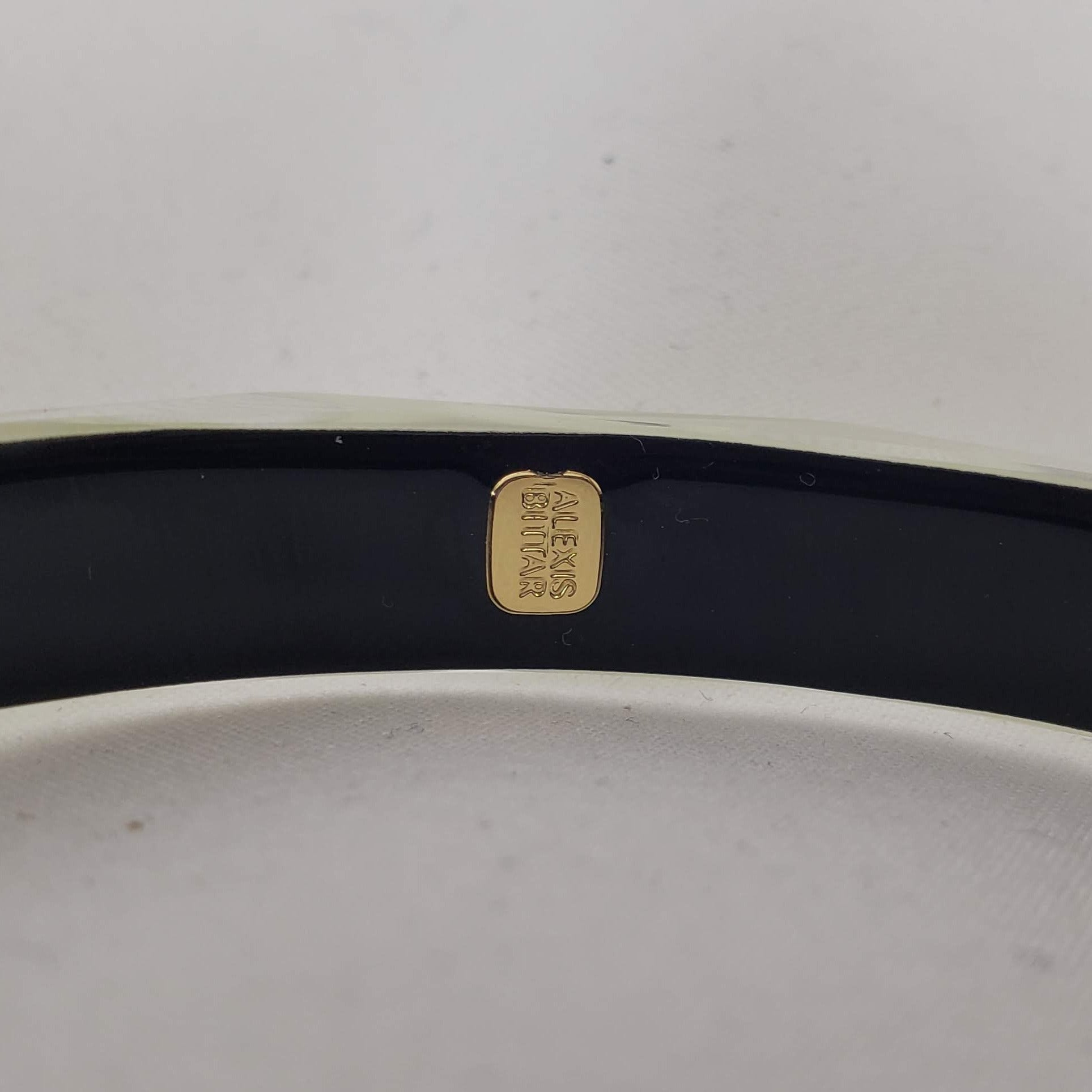 This signature faceted Lucite bangle in clear ivory is sure to impress. This bracelet can be stacked or worn alone. The bracelet is hand sculpted in the United States.  The "Alexis Bittar" tag in on the inside of the bracelet. The piece will fit most wrist sizes with a circumference of 7.5". 