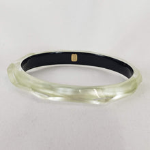 Load image into Gallery viewer, This signature faceted Lucite bangle in clear ivory is sure to impress. This bracelet can be stacked or worn alone. The bracelet is hand sculpted in the United States.  The &quot;Alexis Bittar&quot; tag in on the inside of the bracelet. The piece will fit most wrist sizes with a circumference of 7.5&quot;. 