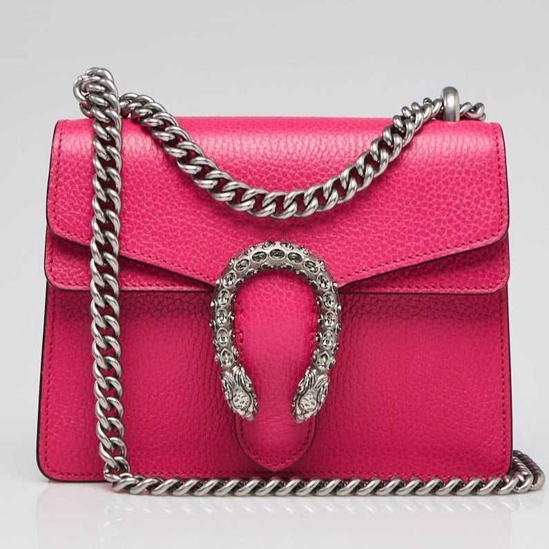 The Gucci Mini Dionysus Shoulder Bag in Pink is a show stopping, rare must have. The top flap is secured with a textured spear head tiger, which references the mystical and powerful god Dionysus and his journey across the Tigris river on the back of the animal. This accent is further enhanced by carefully placed blue Swarovski crystals. 