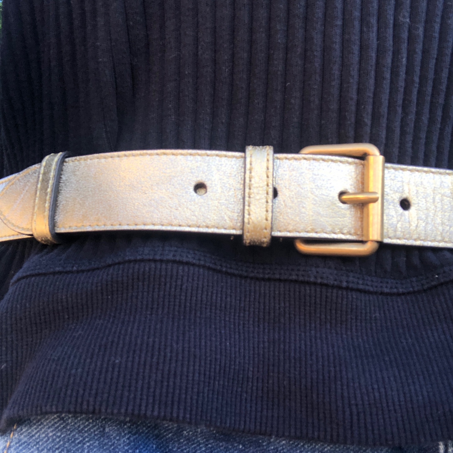 This belt bag is crafted of smooth gold and pink chevron stitched leather. This bag is an oval shape with a leather belt that can be worn as a belt bag. The belt bag features an aged gold GG logo on the front and a heart stitched shape on the back of the bag with an adjustable belt closure. The handbag opens to a blue satin interior with a patch pocket. This compact, yet spacious belt bag is perfect for any time of the day; whether it be for casual or formal wear, from Gucci!