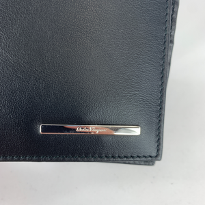 A classic black leather wallet is a staple piece that every man should have. Polished and sophisticated, a simple yet opulent bi-fold wallet will keep all your essentials organized in a compact design that can slip into your pocket. With 6 card slots, 1 full length bill slot, and 2 half sized slip pockets, this slim wallet can fit everything you need with ease. Grab this Ferragamo classic and go about your day with style and superior organization!
