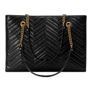 The Gucci GG Marmont Matelassé Leather Shoulder Bag in Black is a gorgeous leather bag with a tote silhouette which is accented by antique gold-tone hardware. Exquisite matelasse stitching accentuates the streamlined silhouette of a trim tote bag branded with antiqued double-G hardware inspired by an archival design.