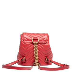 The Gucci Black Marmont Quilted Leather Backpack in Red features adjustable shoulder straps with post-stud fastening. Logo plaque at face. Fold over flap with magnetic tab fastening. Drawstring fastening at throat. Patch pocket and leather logo flag at interior. Leather lining in beige. Antiqued gold-tone hardware. Tonal stitching.