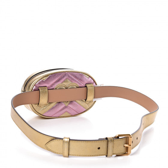 This belt bag is crafted of smooth gold and pink chevron stitched leather. This bag is an oval shape with a leather belt that can be worn as a belt bag. The belt bag features an aged gold GG logo on the front and a heart stitched shape on the back of the bag with an adjustable belt closure. The handbag opens to a blue satin interior with a patch pocket. This compact, yet spacious belt bag is perfect for any time of the day; whether it be for casual or formal wear, from Gucci!
