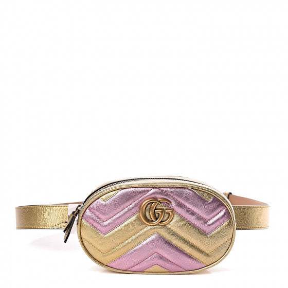 This belt bag is crafted of smooth gold and pink chevron stitched leather. This bag is an oval shape with a leather belt that can be worn as a belt bag. The belt bag features an aged gold GG logo on the front and a heart stitched shape on the back of the bag with an adjustable belt closure. The handbag opens to a blue satin interior with a patch pocket. This compact, yet spacious belt bag is perfect for any time of the day; whether it be for casual or formal wear, from Gucci!