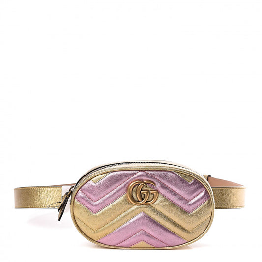 This belt bag is crafted of smooth gold and pink chevron stitched leather. This bag is an oval shape with a leather belt that can be worn as a belt bag. The belt bag features an aged gold GG logo on the front and a heart stitched shape on the back of the bag with an adjustable belt closure. The handbag opens to a blue satin interior with a patch pocket. This compact, yet spacious belt bag is perfect for any time of the day; whether it be for casual or formal wear, from Gucci!