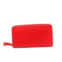 Load image into Gallery viewer, Tory Burch knows how to make bold accessories, and this wallet is no exception! A slim design in lipstick red in a classic silhouette, this wallet is great to match with the Thea clutch or with a classic black handbag for a brilliant contrast of dark and light. The lined interior has a 2 main compartments, a middle zip compartment, 2 cash pockets, and 8 card slots to keep you organized throughout the day. Make the Taylor zip wallet the next staple in your bag!