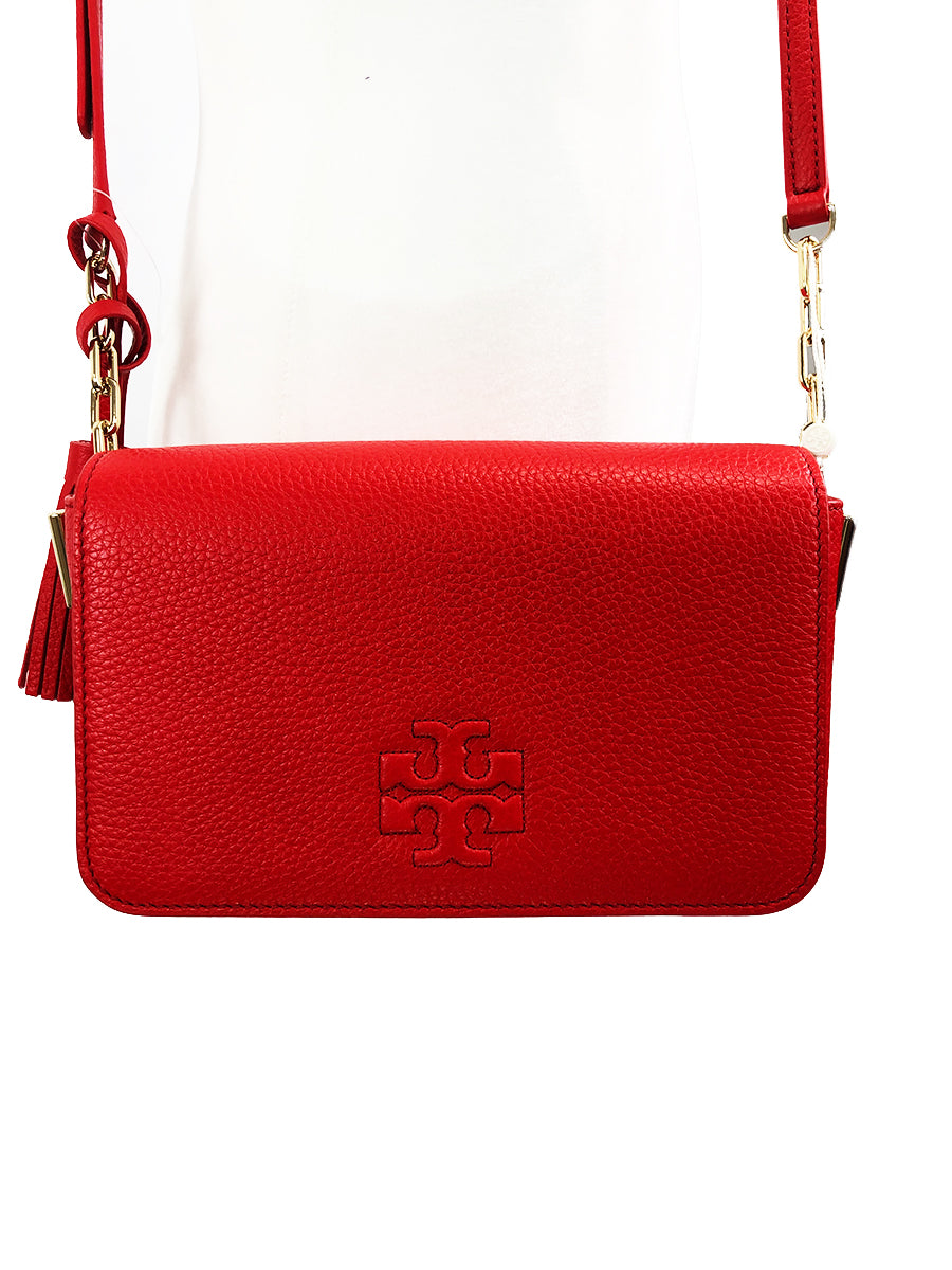 Imported Pebbled leather with removable tassels. Flap top with magnetic snap closure with stitch T-logo detail. Adjustable leather strap for shoulder/crossbody wear, 21" drop and detachable strap as well for use as clutch. Interior: Logo lining; one multifunction slip pocket. Approximate measurements: 8" L x 5-1/2" L x 3-1/4" W.