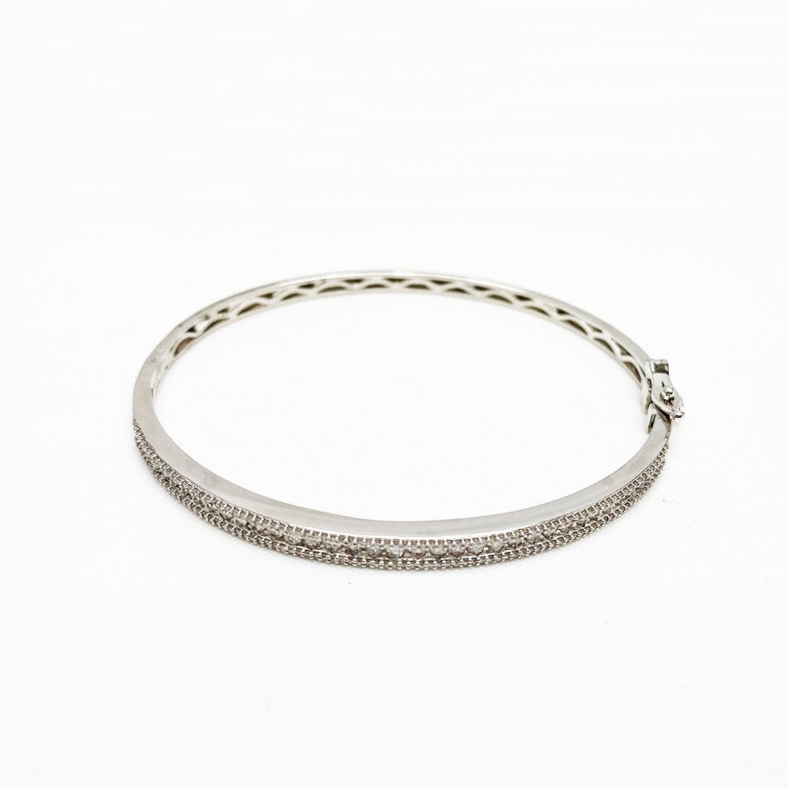Elegance is key in this IGI certified cuff bracelet. Encrusted with 203 carefully lain diamonds, this bracelet shines with a radiance that is sure to brighten your outfit. 10k white gold was crafted with a high polish finish into a band that securely fastens to your write with a hinge, snap closure. When you're going to a classy night out, this simplistic yet sophisticated bracelet will perfectly tie together your look.