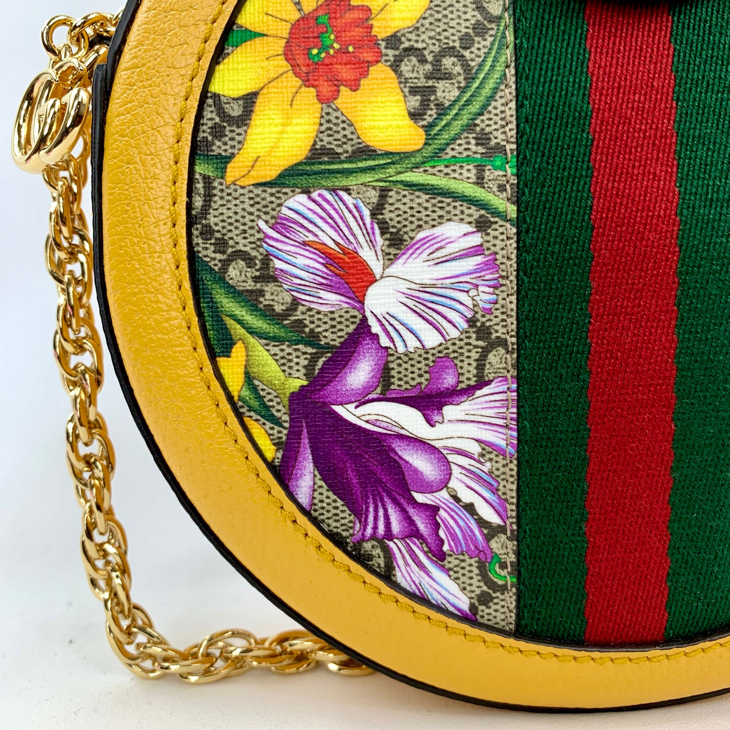 Yellow Ophidia GG Flora round crossbody bag Flora patterned body Beige interior lining  Gold-toned hardware  GG Supreme canvas Leather trim, accents, and strap Signature Gucci web GG logo accent at top and small charm 7.5" x 7.5" x 1.75" Strap drop 22.75" Product number 550618 Made in Italy 
