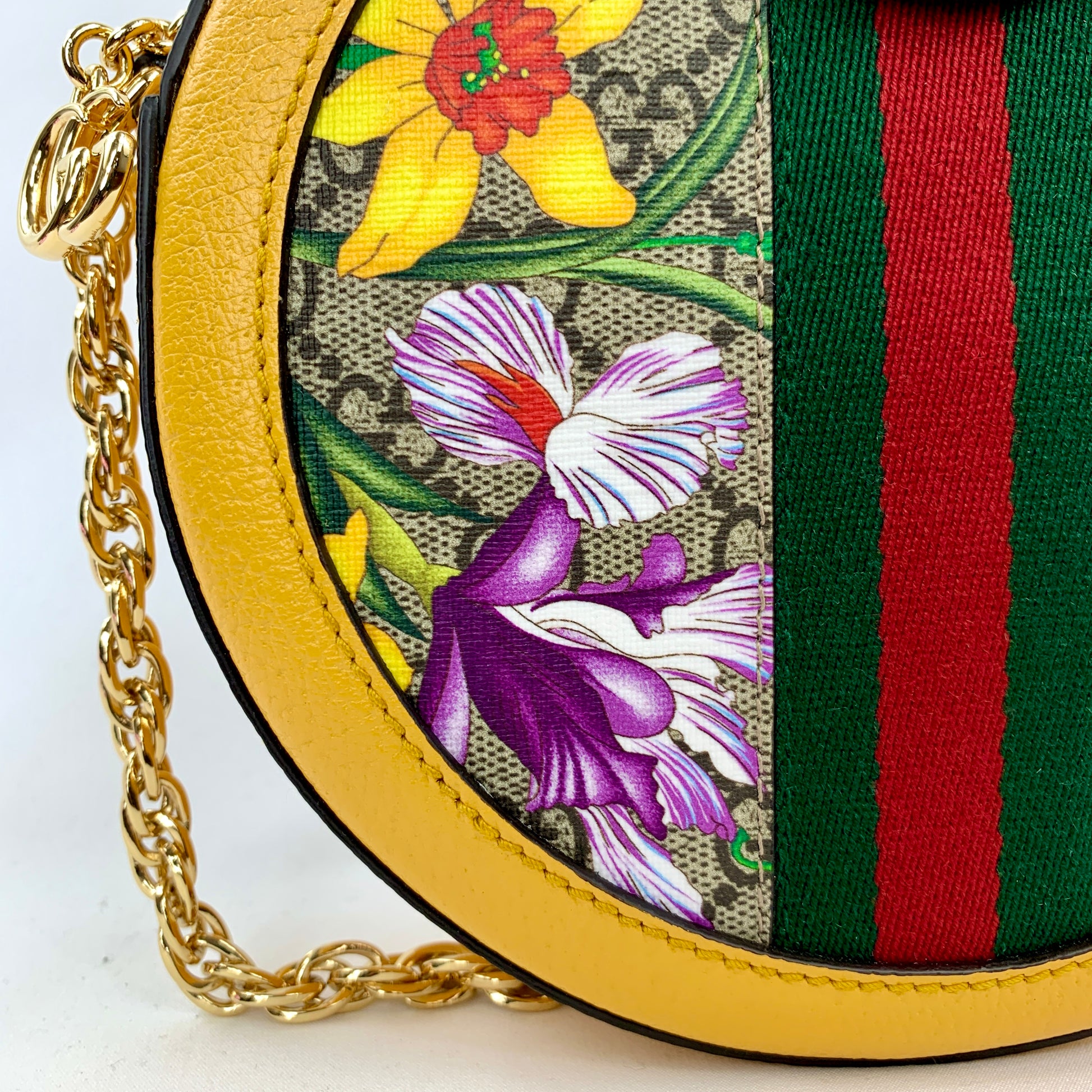 Yellow Ophidia GG Flora round crossbody bag Flora patterned body Beige interior lining  Gold-toned hardware  GG Supreme canvas Leather trim, accents, and strap Signature Gucci web GG logo accent at top and small charm 7.5" x 7.5" x 1.75" Strap drop 22.75" Product number 550618 Made in Italy 