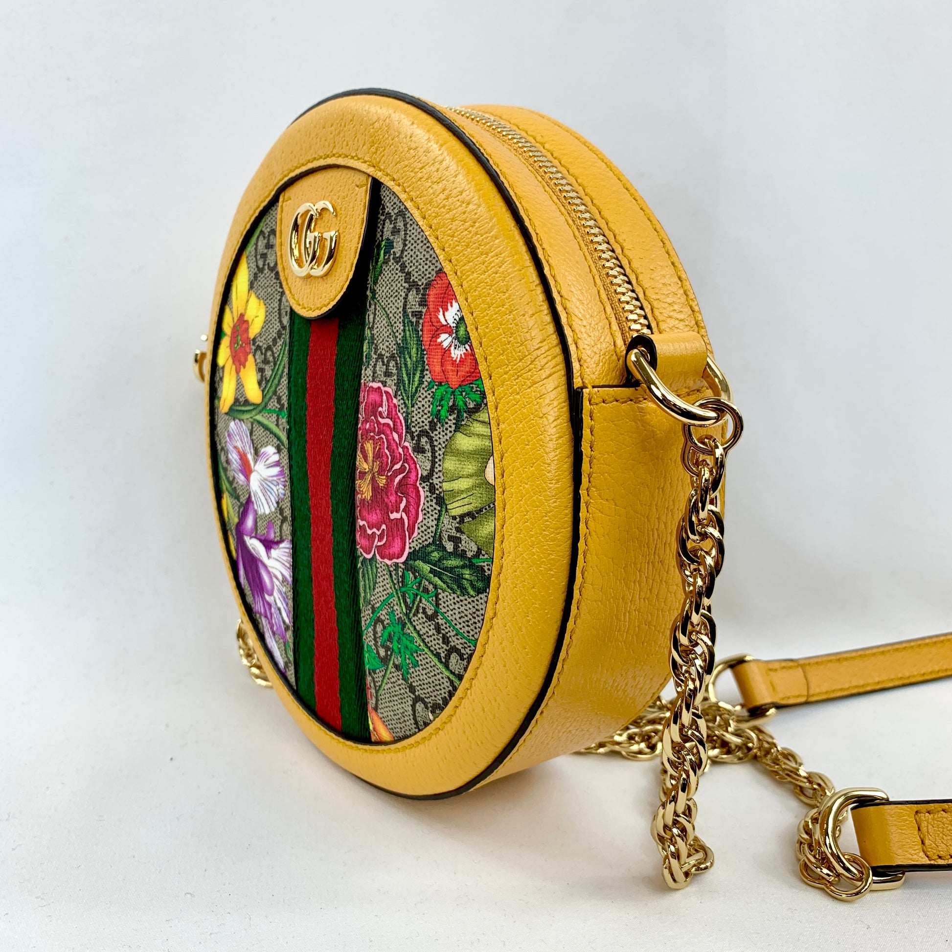 A Double GG logo sits at the top of this bag as well as in a cute charm on the side, and a polished gold-tone chain with a leather pad acts as the shoulder strap. The spacious interior is large enough to fit a cell phone or wallet, making this the bright, fun, and luxurious bag you've been waiting for!