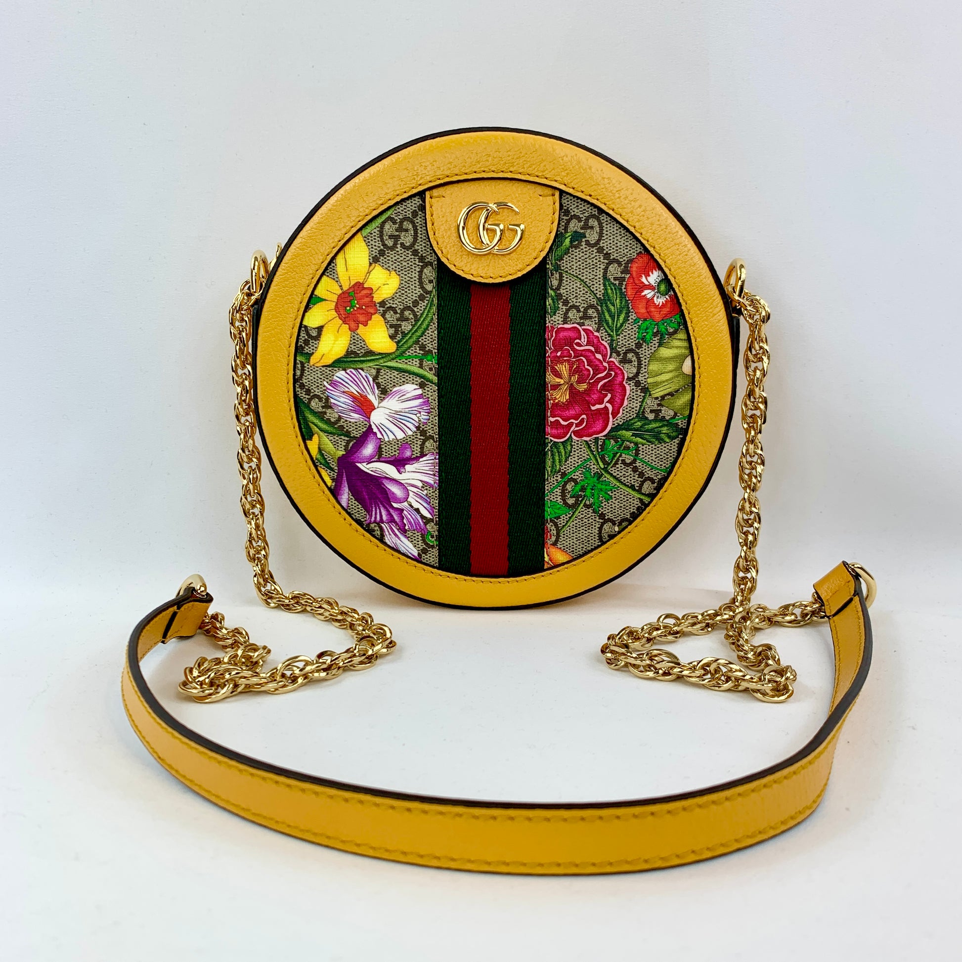 A Double GG logo sits at the top of this bag as well as in a cute charm on the side, and a polished gold-tone chain with a leather pad acts as the shoulder strap. The spacious interior is large enough to fit a cell phone or wallet, making this the bright, fun, and luxurious bag you've been waiting for!