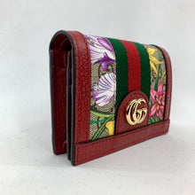 Load image into Gallery viewer, The top flap with snap closure opens to a zipped coin pouch, 1 bill slot, and 5 card slots. Coming in a forest green dust bag and holographic palm tree box, this wallet can be used and stored in style!