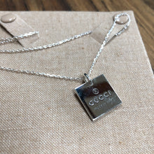 Load image into Gallery viewer, Gucci sterling silver necklace with lobster clasp.  Square pendant with GUCCI logo and &quot;made in Italy&quot; stamped for design.  Simple, classy, everyday piece.