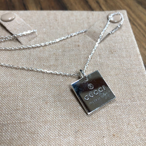 Gucci sterling silver necklace with lobster clasp.  Square pendant with GUCCI logo and "made in Italy" stamped for design.  Simple, classy, everyday piece.