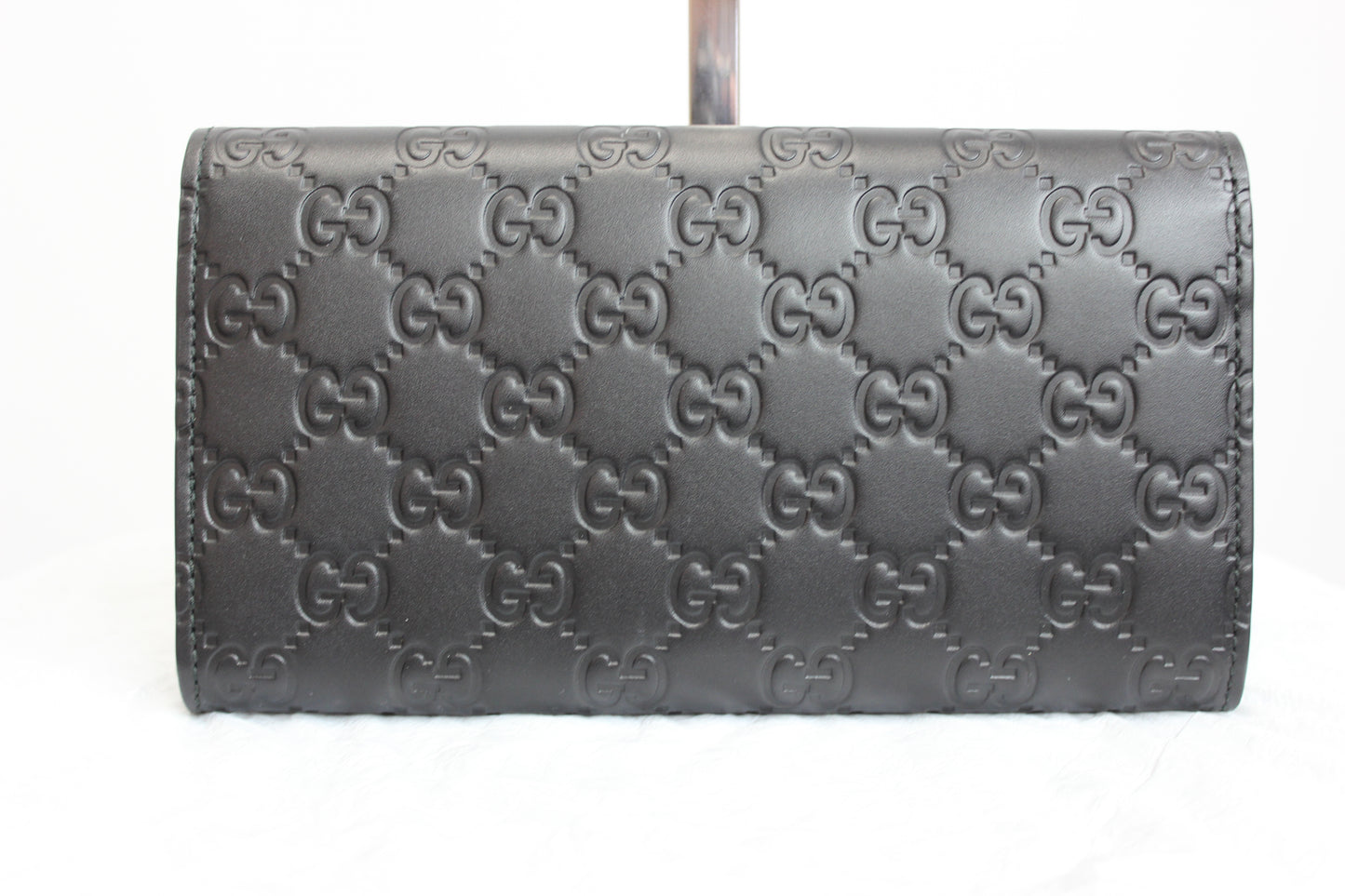 Black snap wallet Gold-toned hardware Interlocking Double G pattern 100% leather 2 main compartments, 2 bill slots, 12 card holders, zipped pouch 4.25" x 7.5" x 1.24" Product number 410100 Made in Italy