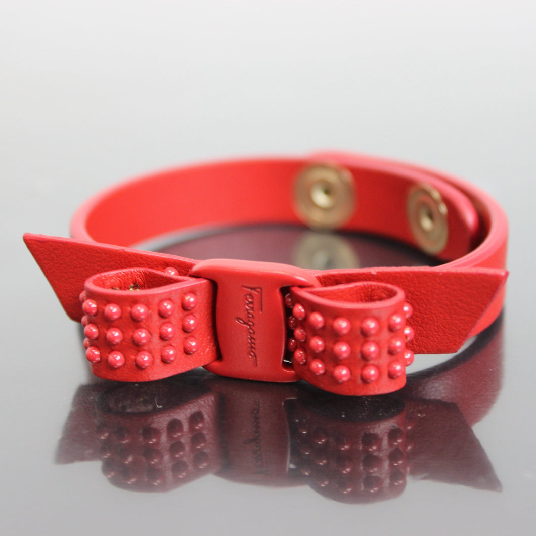 Bracelets can spice up any outfit, and this lipstick red bracelet will do just that. Soft leather was elegantly shaped to create a vara bow, which features stylish red studs and, of course, the classic Ferragamo name. Adjustable to fit your wrist perfectly, this bracelet is meant to be shown off!