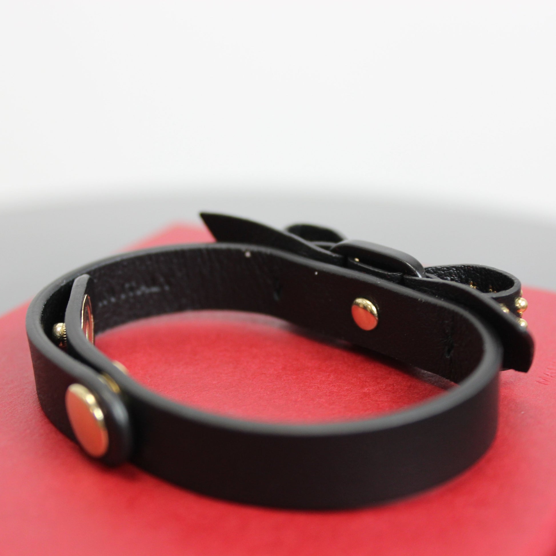 Black bracelet Signature vara bow with gold studs Features Ferragamo logo at the center 100% leather snap closures 8" x 0.5" strap Adjustable snaps at 7.75" and 6.75" Product number 62061708 Made in Italy