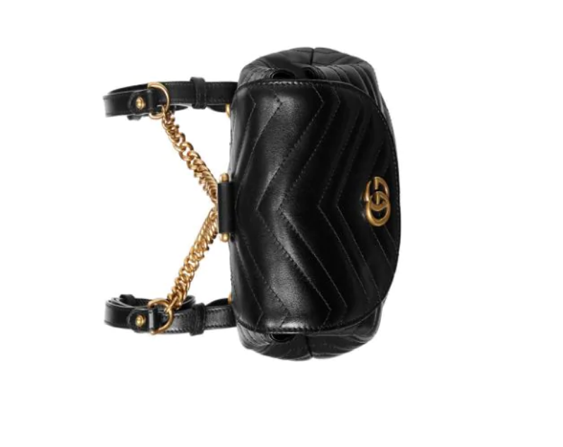 The Gucci Black Marmont Quilted Leather Backpack features adjustable shoulder straps with post-stud fastening. Logo plaque at face. Fold over flap with magnetic tab fastening. Drawstring fastening at throat. Patch pocket and leather logo flag at interior. Leather lining in beige. Antiqued gold-tone hardware. Tonal stitching.