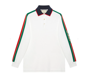 Gucci Men long sleeve polo with classic Gucci red and green stripe down each arm, "GUCCI" logo on left stripe in block letters.  White cotton polo with navy blue collar with red trim.  Three button down.  Tasteful yet eye catching. Size Large