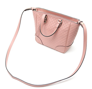 Pink crossbody tote bag Gold-tone hardware featuring Gucci charm 100% leather in GG Microguccissima pattern Linen interior lining Top zip closure Detachable and adjustable shoulder strap 2 slip pouches, 1 zipped pocket Leather tassel detail 8.5" x 11.5" x 4.5"  Strap Drop 19-21 Handle drop 3.5" Product number 449241 Made in Italy 